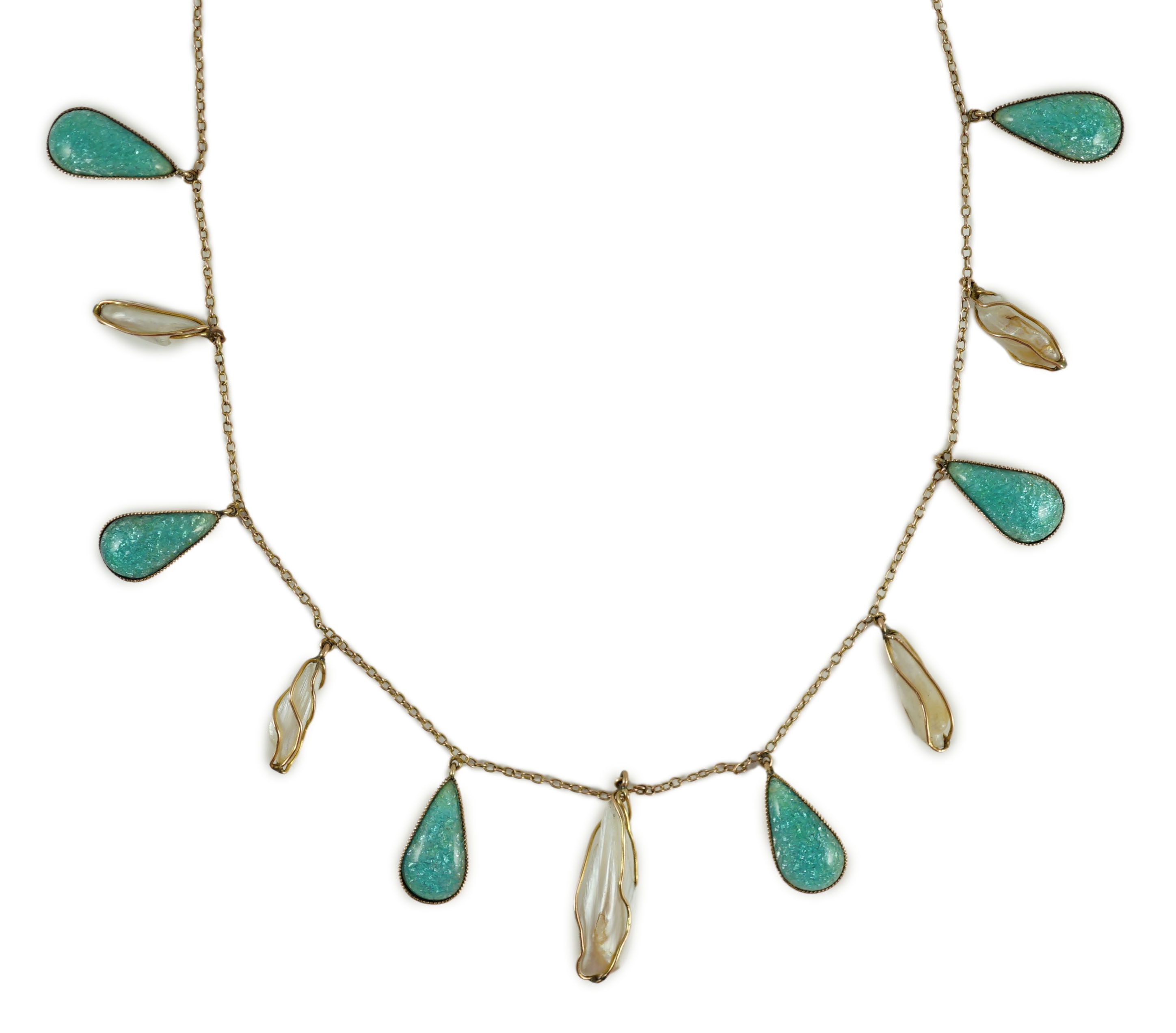 An early 20th century gold, enamel and baroque pearl set drop fringe necklace, in the manner of Liberty & Co